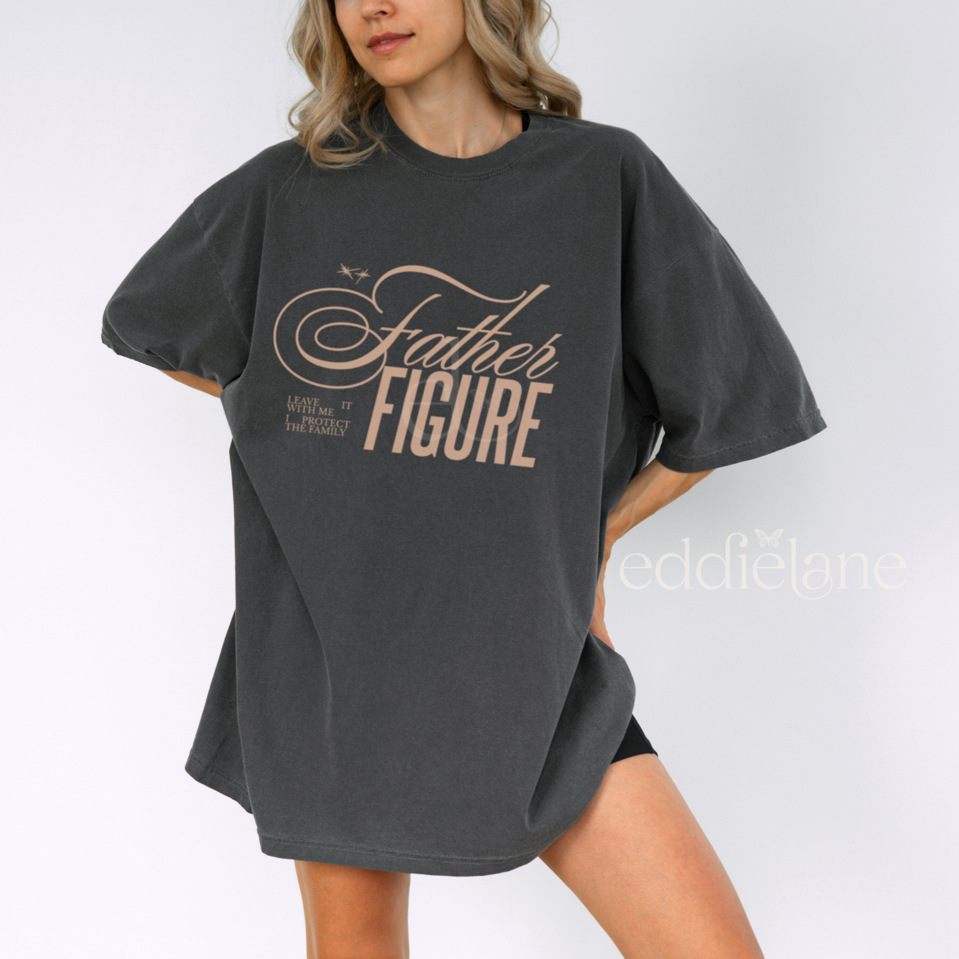 Woman wearing an oversized gray comfort colors t-shirt with the words 'Father Figure'
