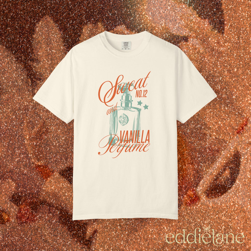 woman wearing an ivory comfort colors graphic tee with an illustration of a perfume bottle and the words "sweat and vanilla perfume" 