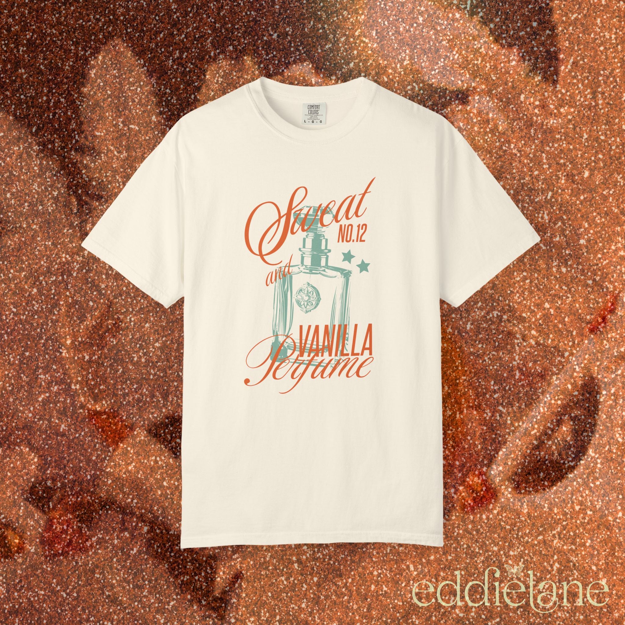 woman wearing an ivory comfort colors graphic tee with an illustration of a perfume bottle and the words "sweat and vanilla perfume" 