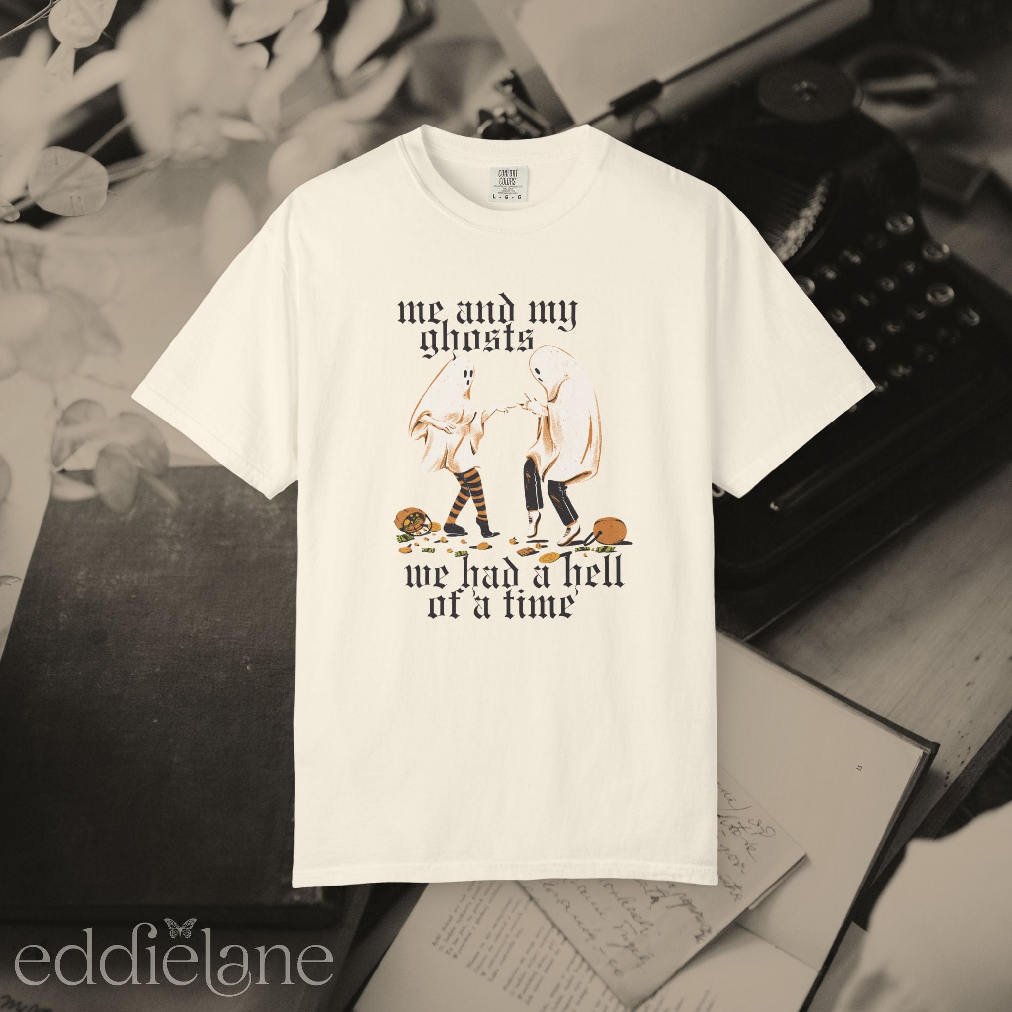 an ivory halloween graphic tee with a vintage aesthetic, featuring a graphic of two ghosts and the words "me and my ghosts we had a hell of a time"