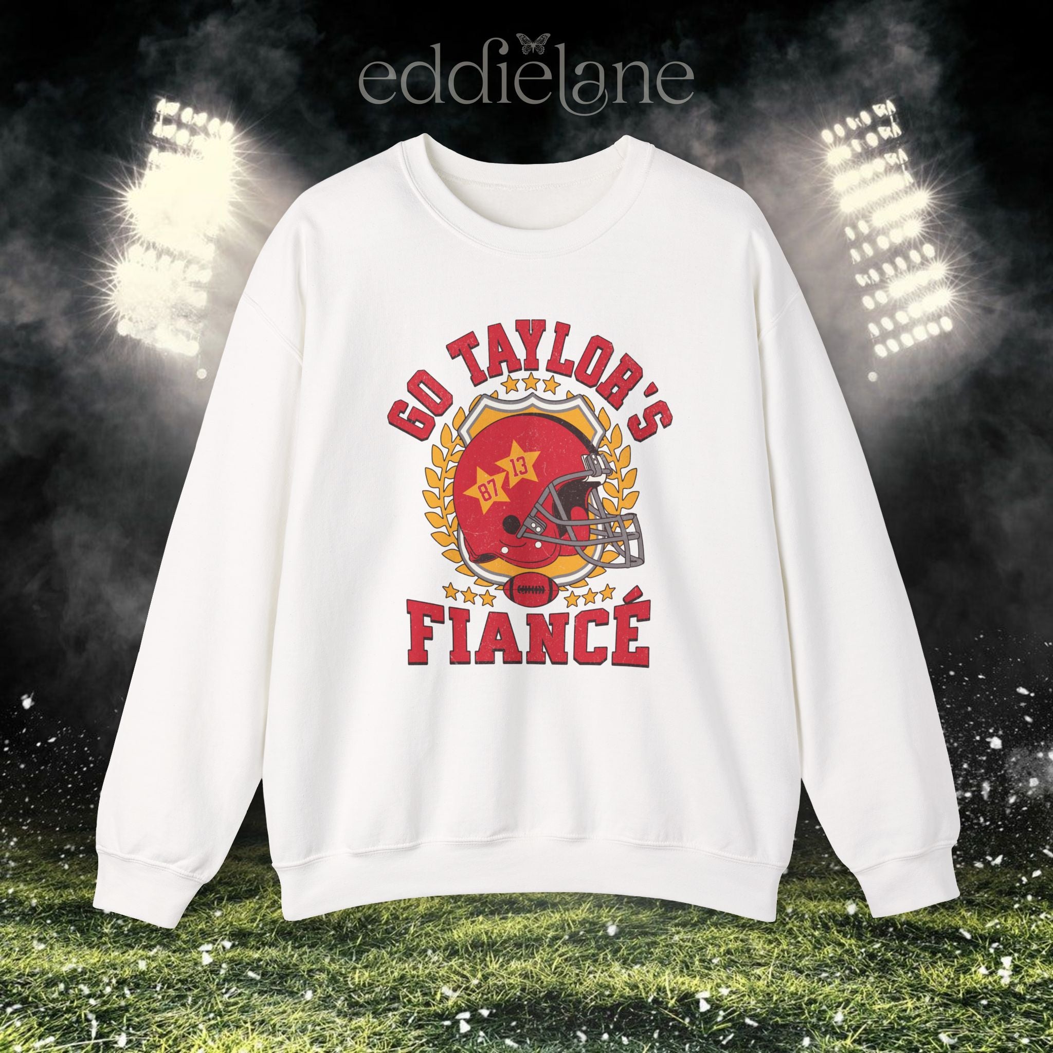 a white crewneck sweatshirt with a vintage football helmet design and text that says "go taylor's fiance"
