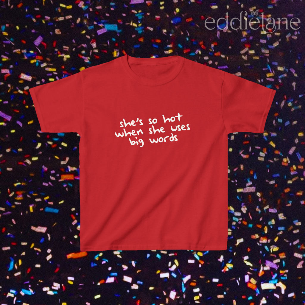 a red baby tee that says "she's so hot when she uses big words"