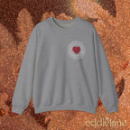a gray sweatshirt with a red heart design inspired by the fate of ophelia