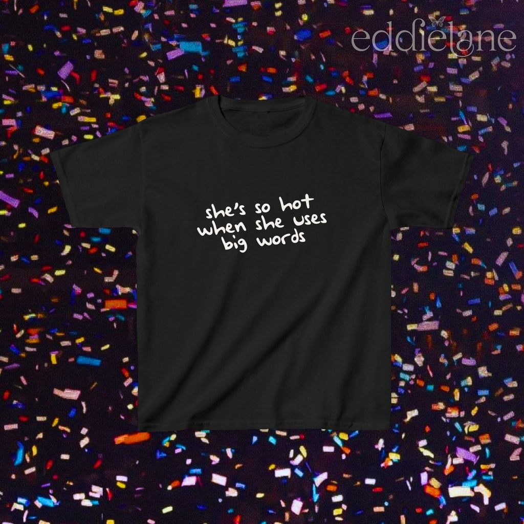 a black baby tee that says "she's so hot when she uses big words"