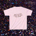 a light pink baby tee that says "she's so hot when she uses big words"