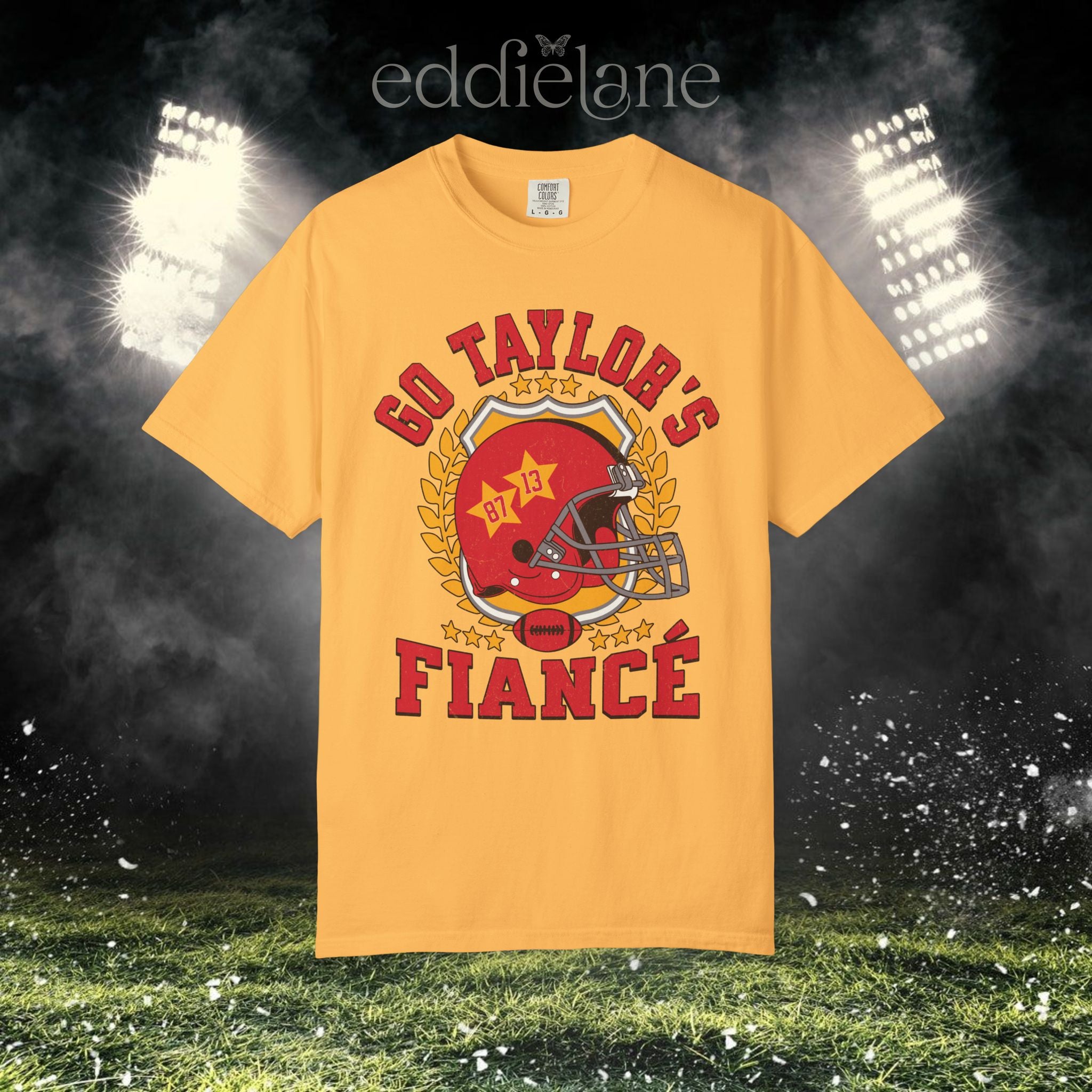 a yellow t-shirt with a vintage football helmet design and text that says "go taylor's fiance"