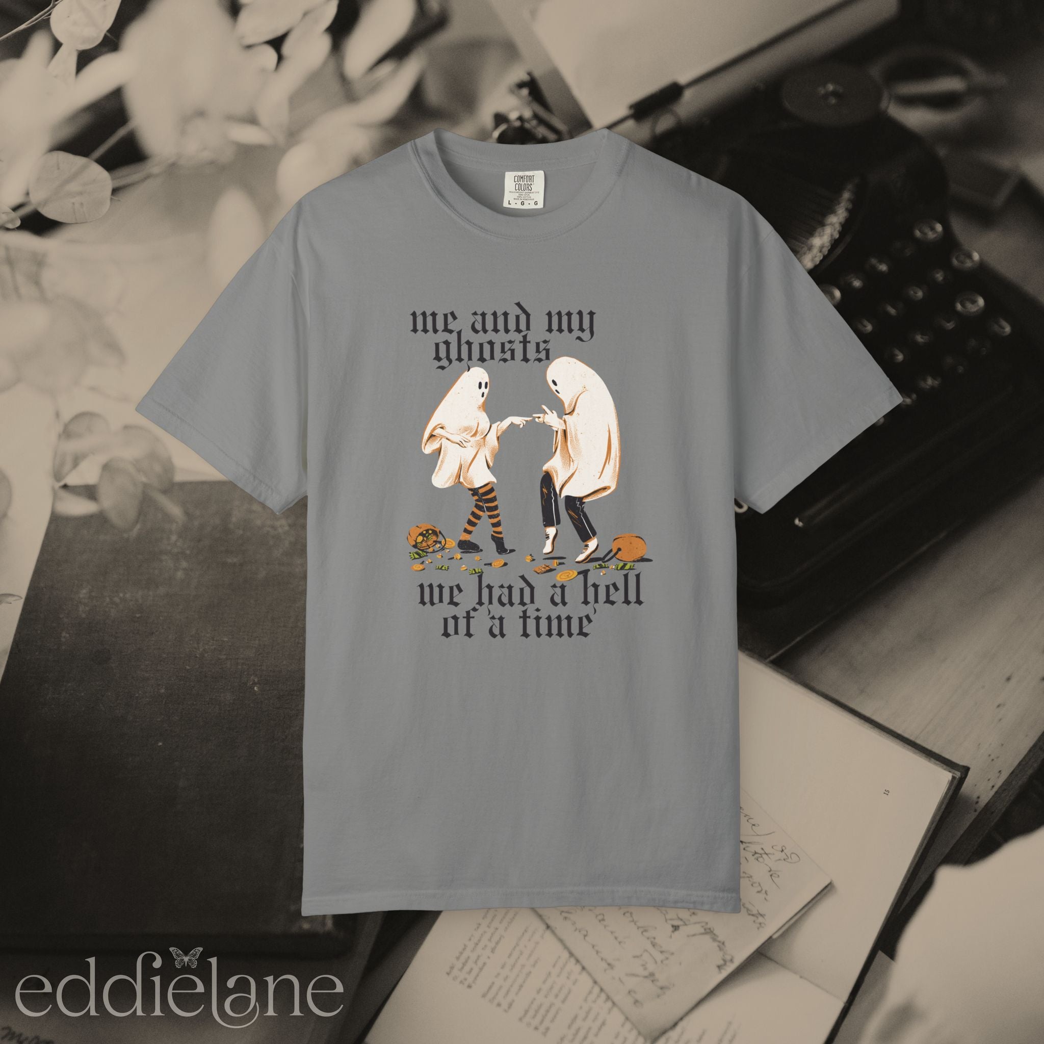 a gray halloween graphic tee with a vintage aesthetic, featuring a graphic of two ghosts and the words "me and my ghosts we had a hell of a time"