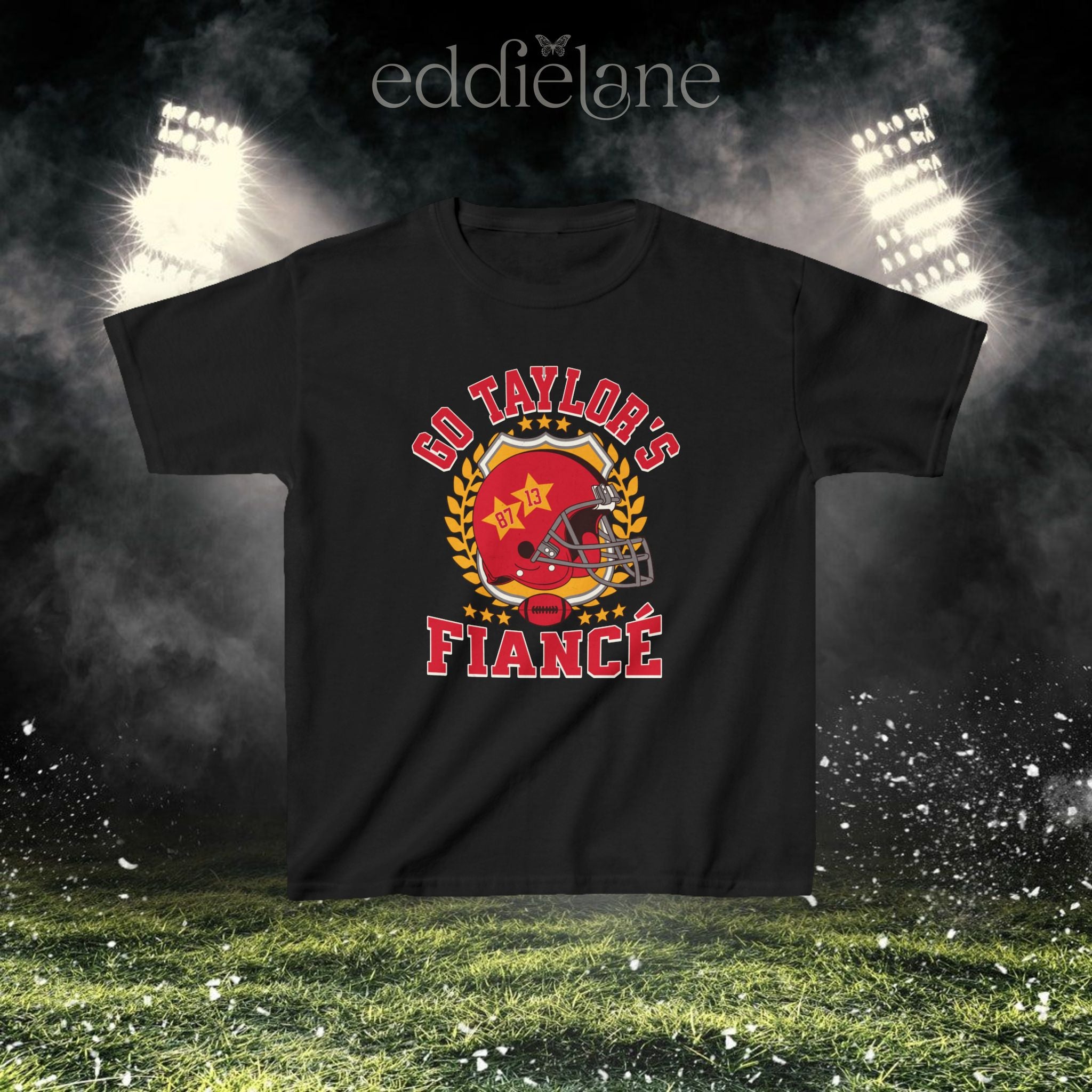 a black baby tee with a vintage football helmet design and text that says "go taylor's fiance"