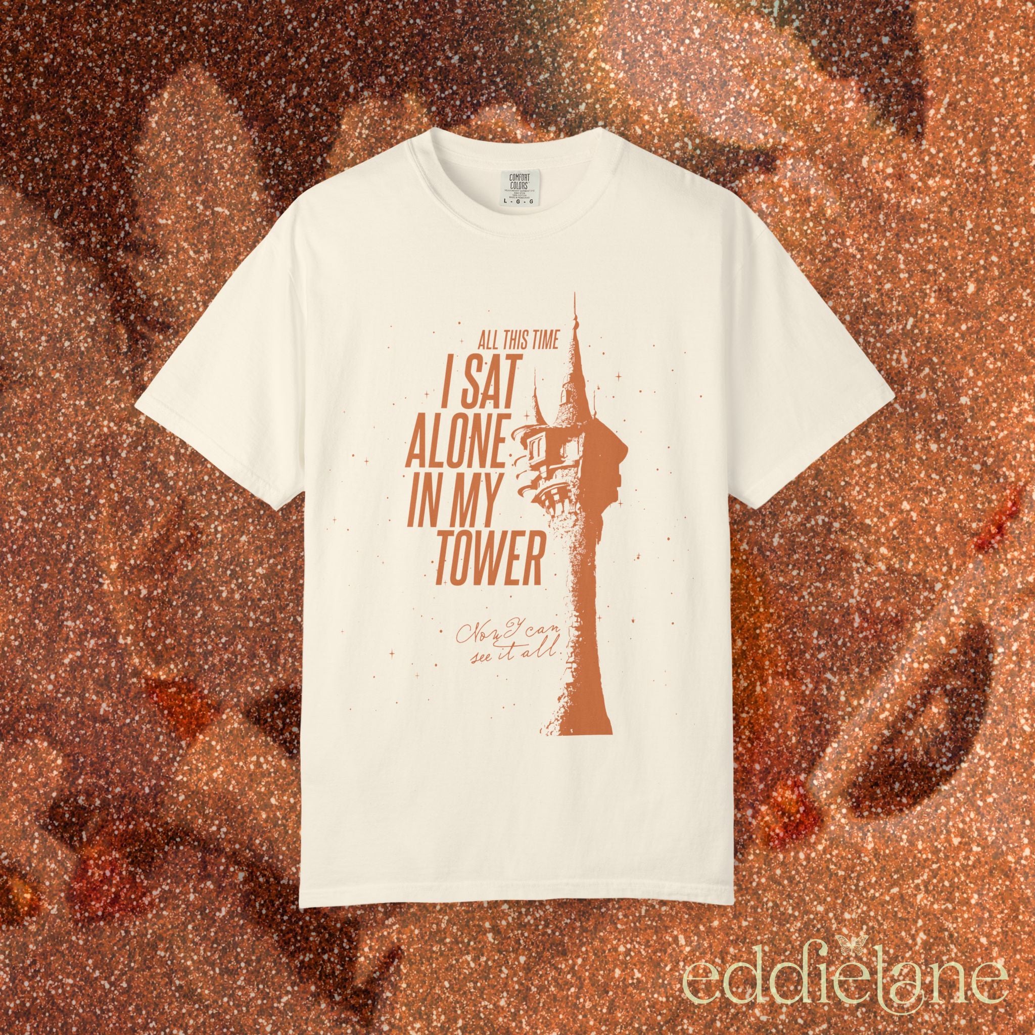 an ivory comfort colors shirt with a graphic of a tower and the words "all this time i sat alone in my tower"