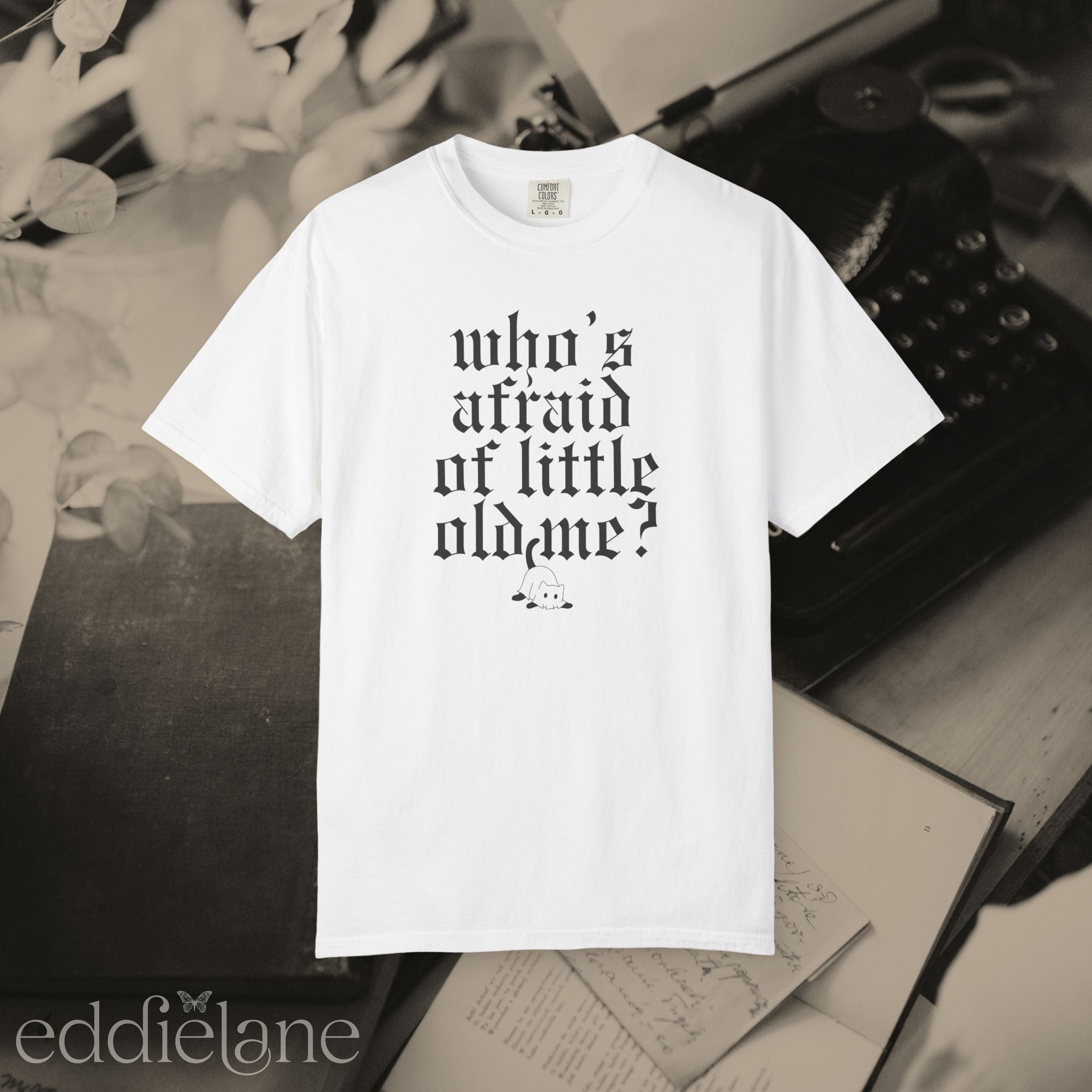 a white comfort colors t-shirt that says "who's afraid of little old me" with a graphic of a cat wearing a ghost costume