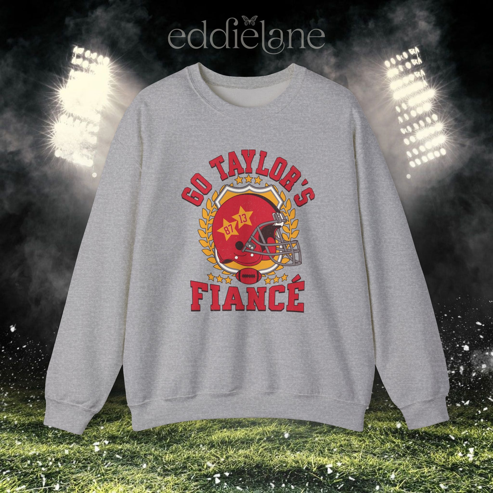 a sport gray crewneck sweatshirt with a vintage football helmet design and text that says "go taylor's fiance"