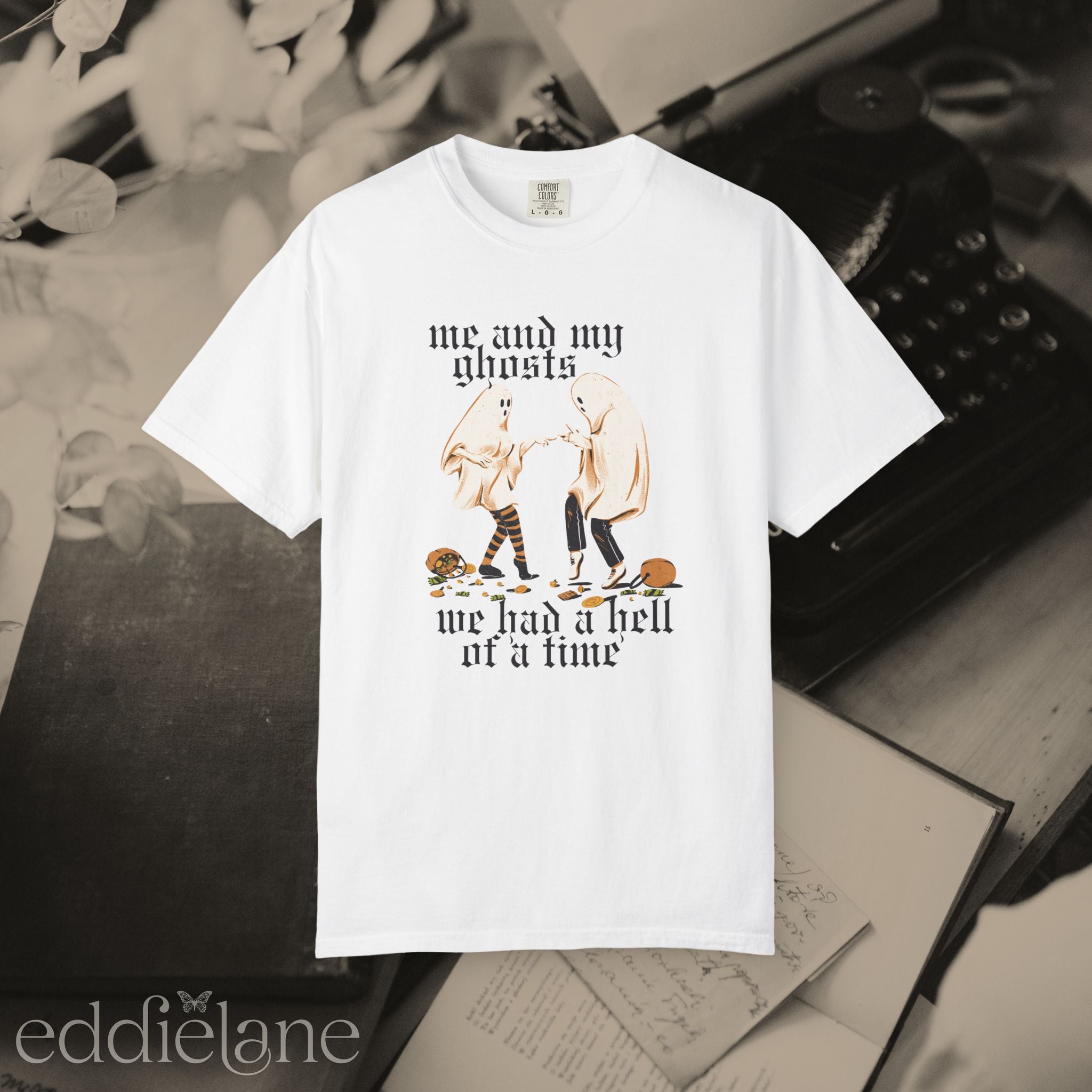 a white halloween graphic tee with a vintage aesthetic, featuring a graphic of two ghosts and the words "me and my ghosts we had a hell of a time"