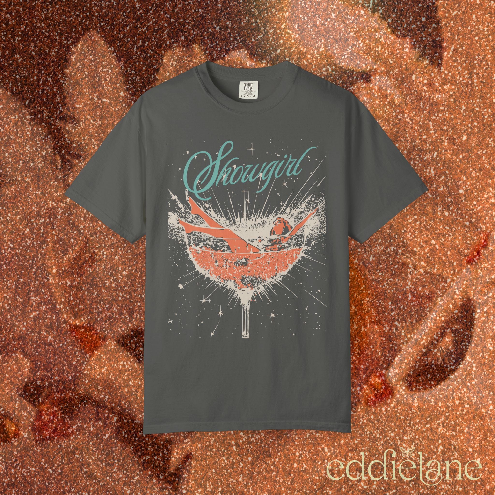 a gray t-shirt featuring a graphic of a woman in a champagne glass surrounded by sparkles