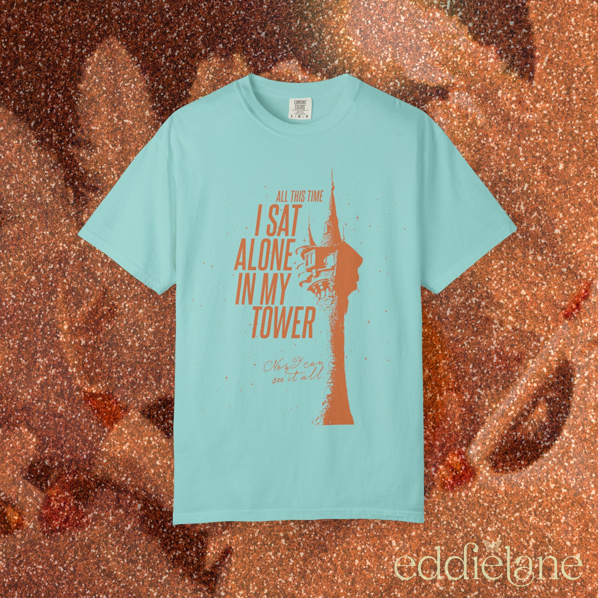 a mint green comfort colors shirt with a graphic of a tower and the words "all this time i sat alone in my tower"