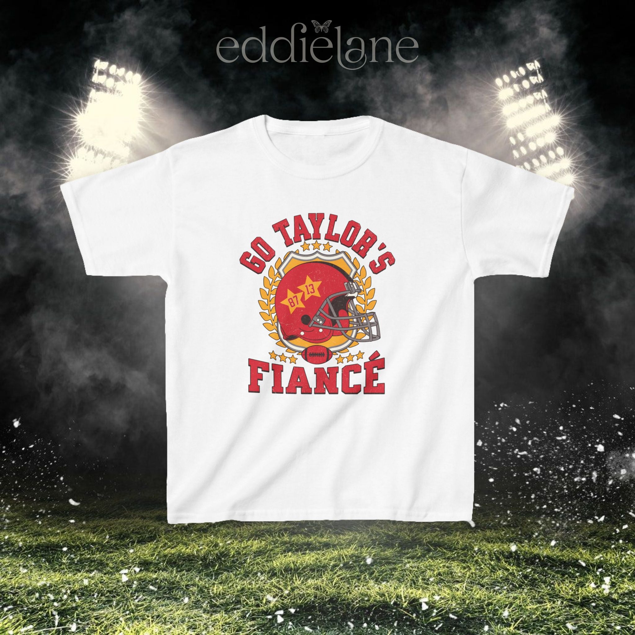 a white baby tee with a vintage football helmet design and text that says "go taylor's fiance"