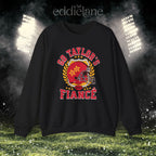 a black crewneck sweatshirt with a vintage football helmet design and text that says "go taylor's fiance"