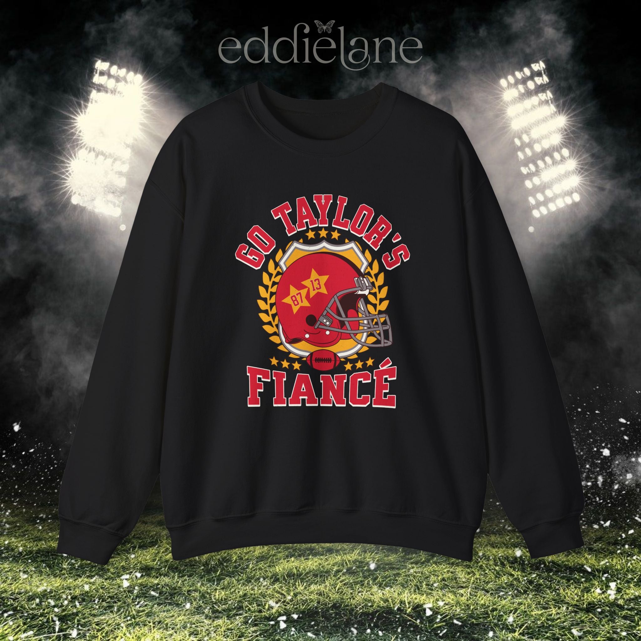a black crewneck sweatshirt with a vintage football helmet design and text that says "go taylor's fiance"
