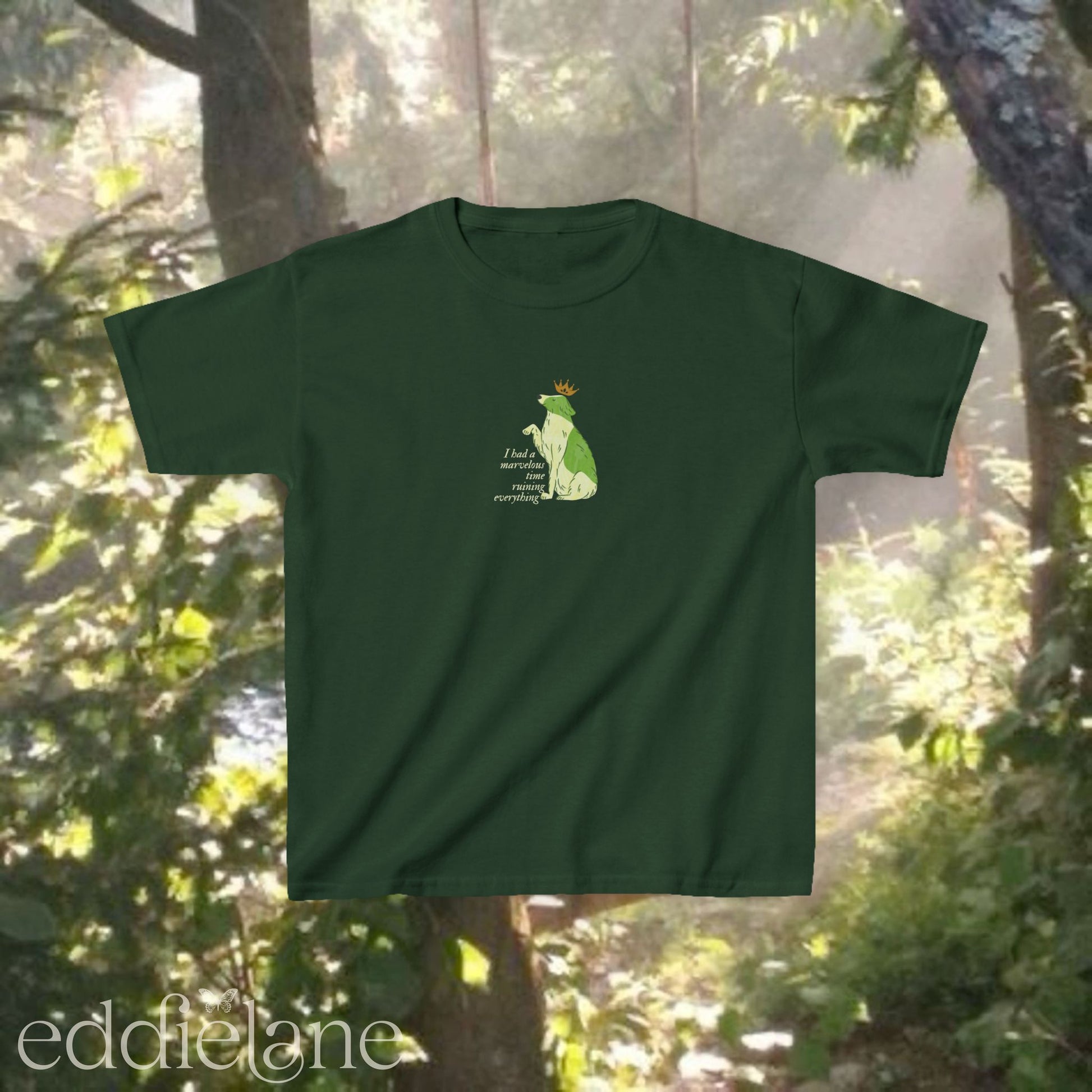 A green baby tee with a graphic of a key-lime green dog wearing a crown and the words "i had a marvelous time ruining everything". Inspired by the song the last great american dynatsy from folklore by taylor swift.
