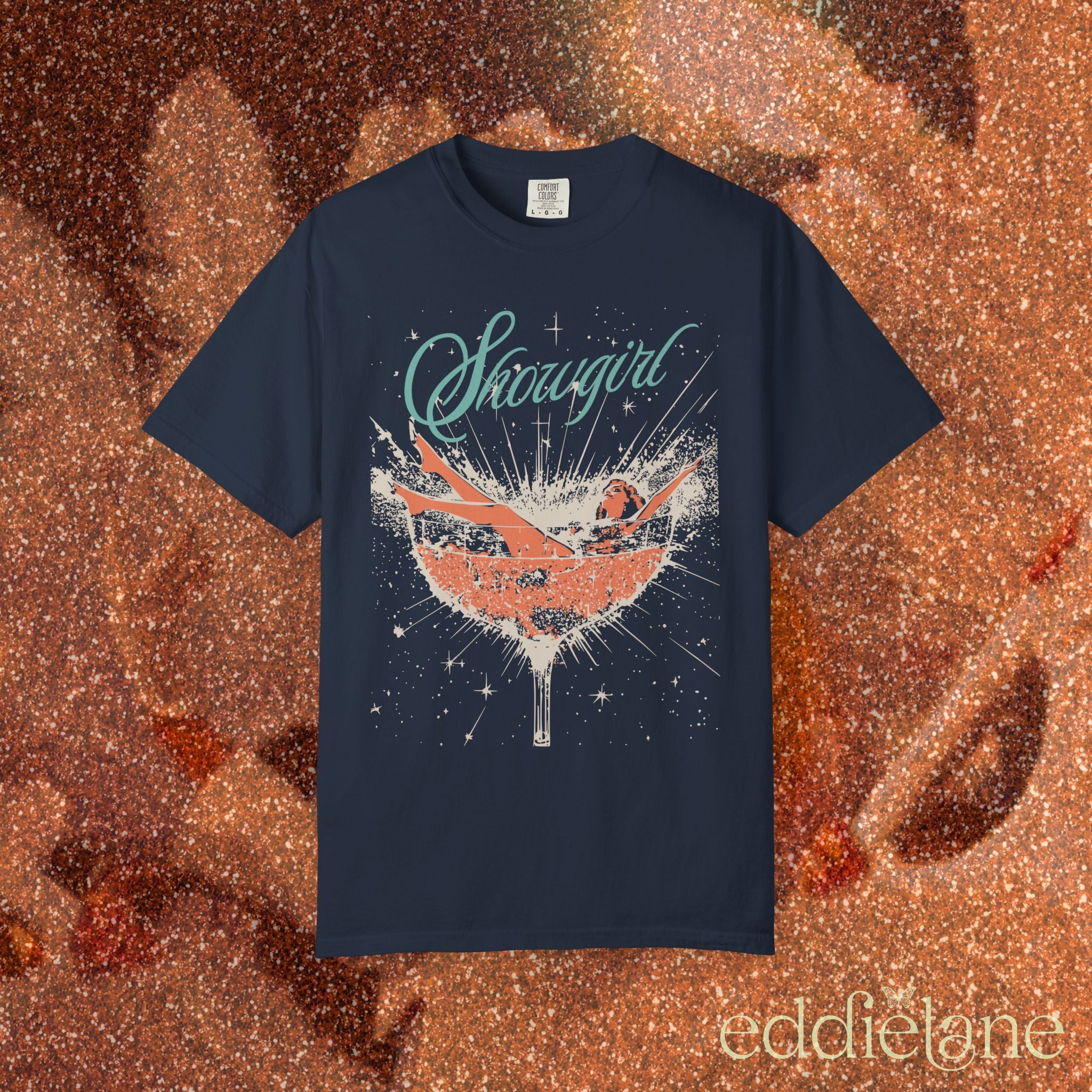 a navy t-shirt featuring a graphic of a woman in a champagne glass surrounded by sparkles