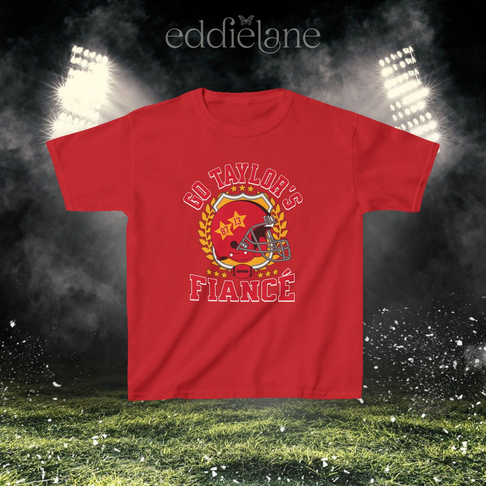 a red baby tee with a vintage football helmet design and text that says "go taylor's fiance"