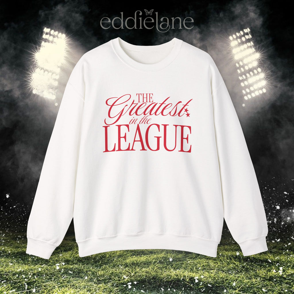 woman in a white crewneck sweatshirt that says "the greatest in the league"