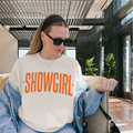 woman wearing an ivory comfort colors graphic tee that says 'SHOWGIRL'

ivory showgirl title tee
