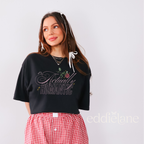 Woman wearing an ivory graphic tee that says 'it's Actually Romantic' 