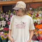 Woman wearing an ivory graphic tee that says 'it's Actually Romantic' 
