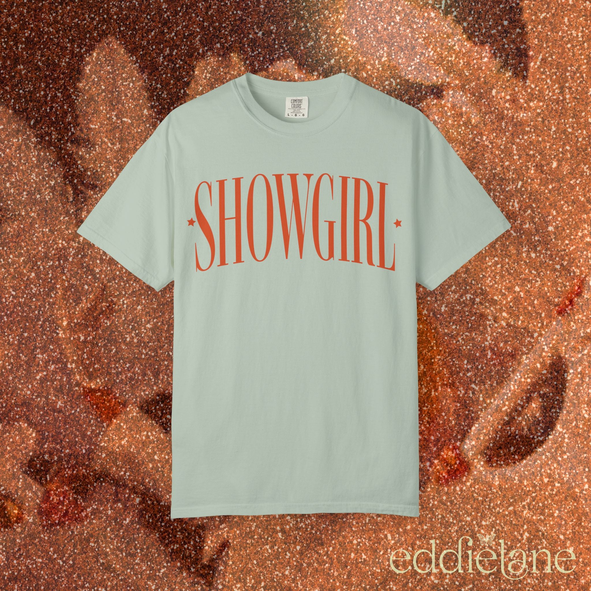 a bay green comfort colors graphic tee that says 'SHOWGIRL' with two small stars 

bay showgirl title tee