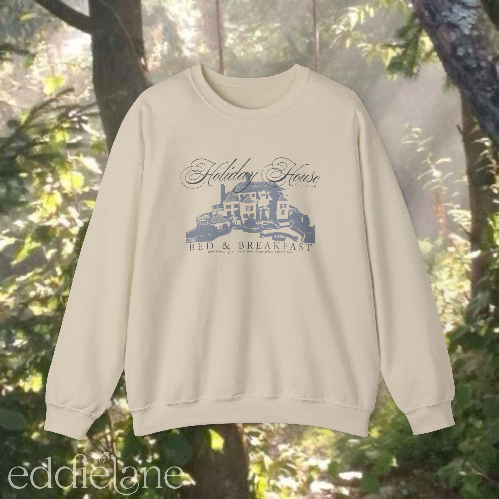 beige crewneck sweatshirt that says "Holiday House Bed and Breakfast" with a silhouette of the holiday house from taylor swift's the last great american dynasty from folklore.
beige swiftie sweatshirt holiday house
