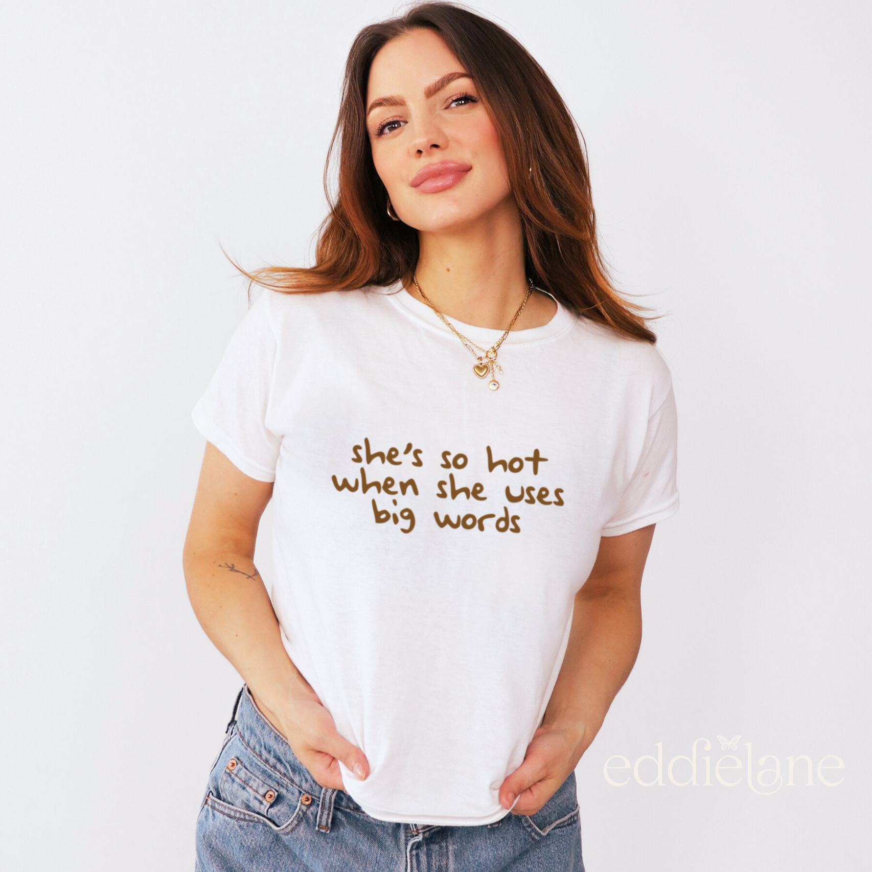 woman wearing a white baby tee that says "she's so hot when she uses big words"