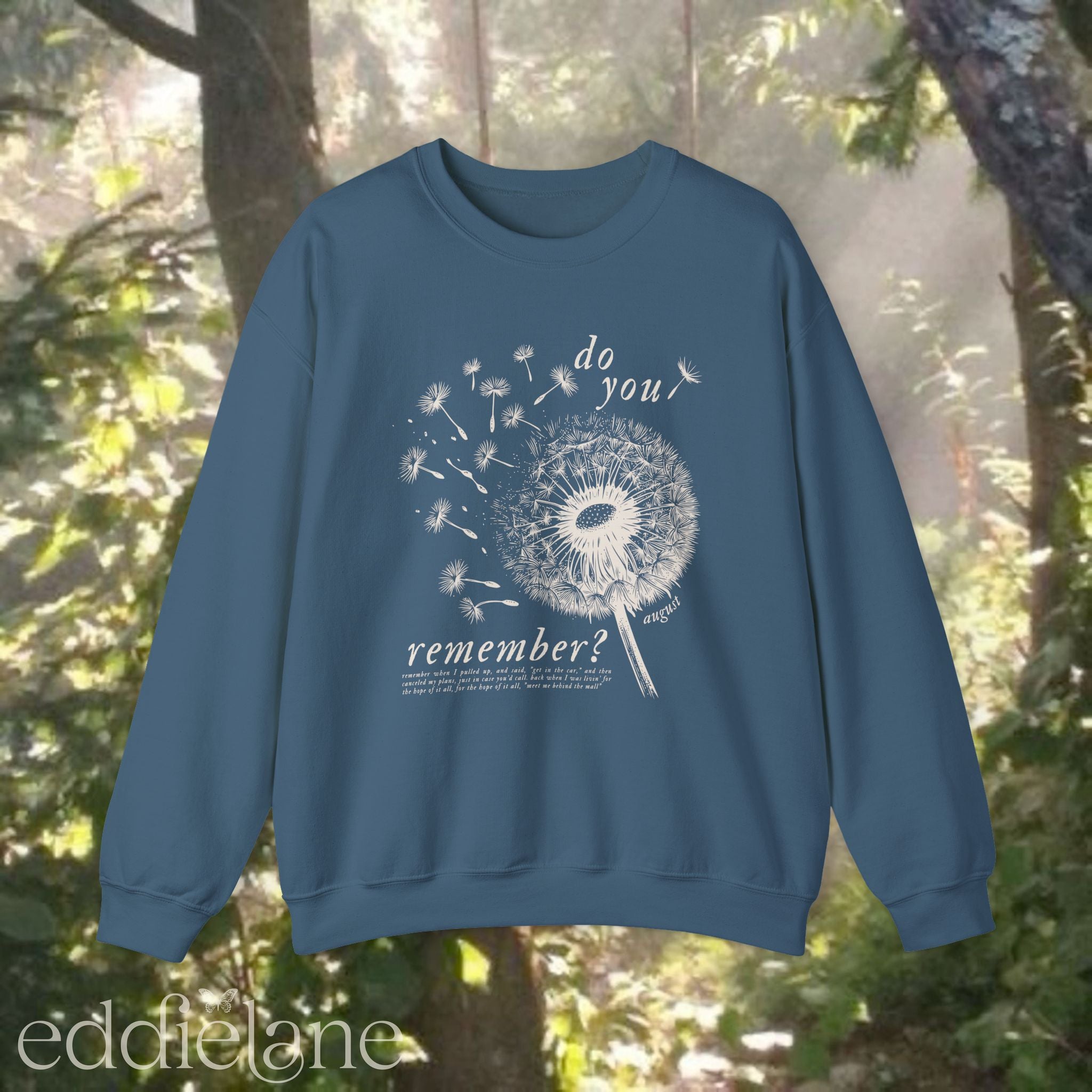 blue sweatshirt with dandelion graphic and text that says "do you remember" 