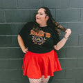 Woman wearing a black collegiate-style t-shirt that says "burnin up" 