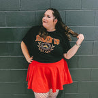 Woman wearing a black collegiate-style t-shirt that says "burnin up" 