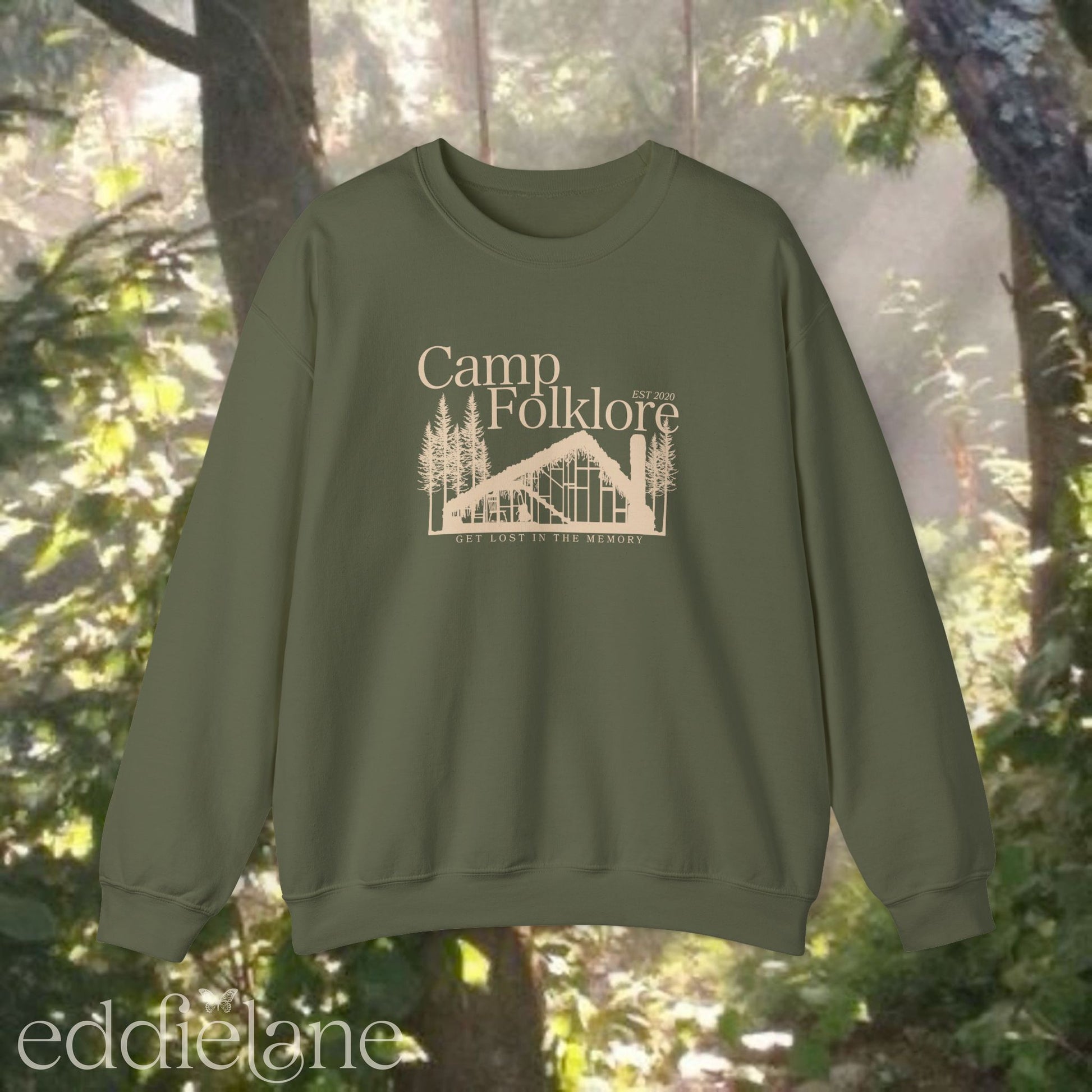 Light green sweatshirt with 'Camp Folklore' design featuring the Folklore cabin inspired by Taylor Swift's Folklore album.
camp folklore sweatshirt light green