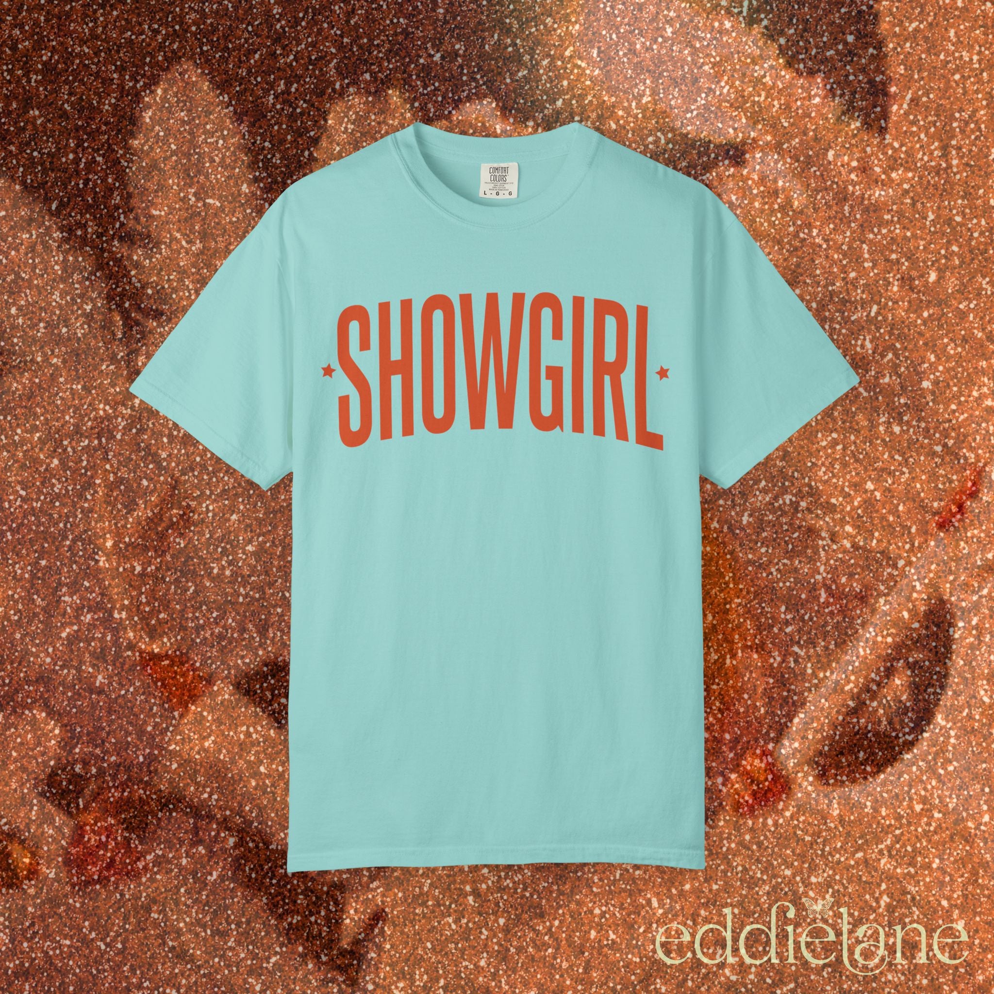 chalky mint comfort colors graphic tee that says 'SHOWGIRL' with two small stars 

chalky mint showgirl tee