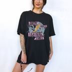 Woman wearing a black t-shirt with a colorful disco ball and lightning bolts graphic design with the words "dancing through the lightning strike"