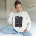 Woman wearing a white sweatshirt with a picutre of a painting and the words "Locked inside my memory and only you possess the key no longer drowning and deceived all because you came for me"