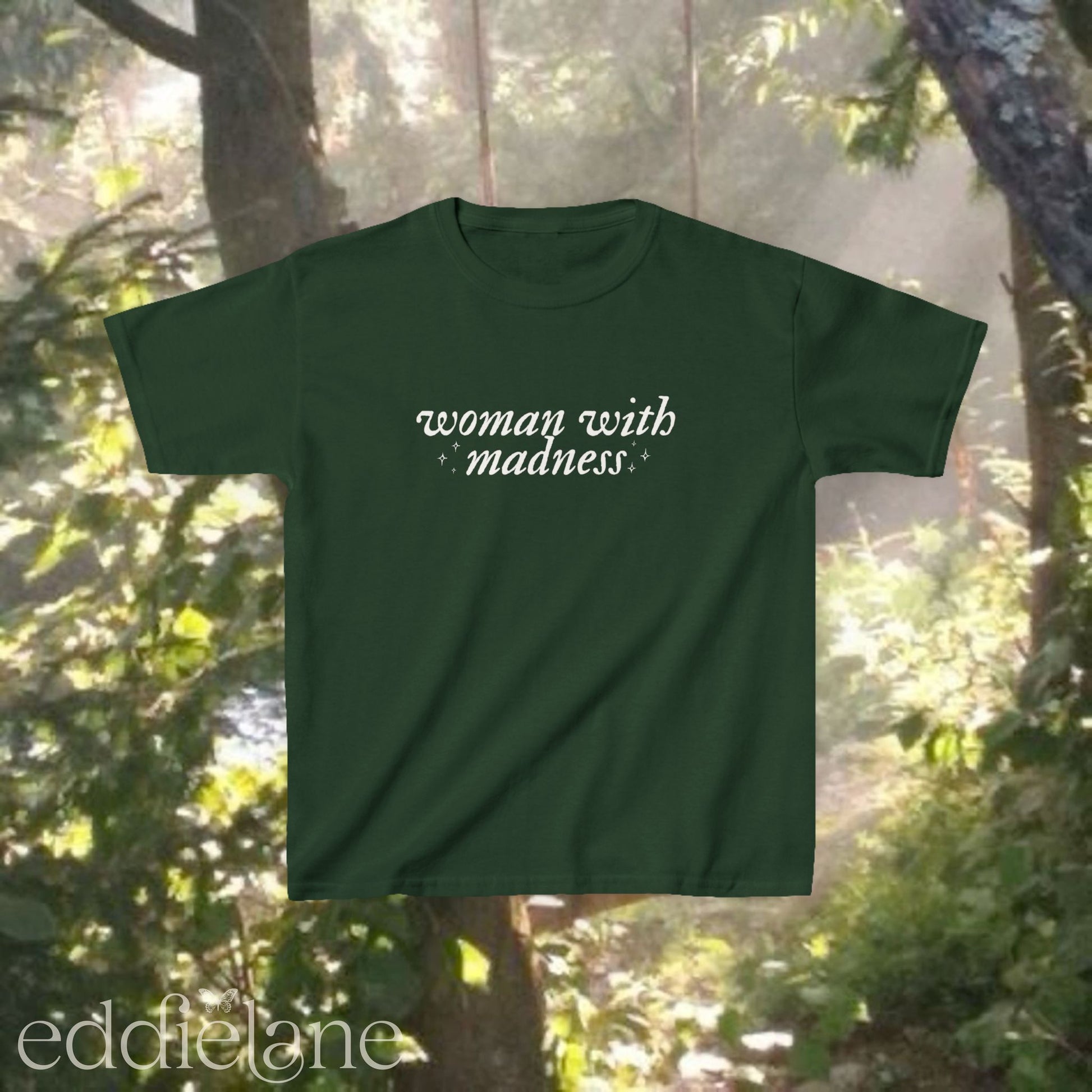 Forest green baby tee with words "woman with madness" inspired by the last great american dynasty from folklore by taylor swift.
