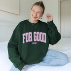 Person wearing a green sweatshirt with 'FOR GOOD' text in a collegiate font.