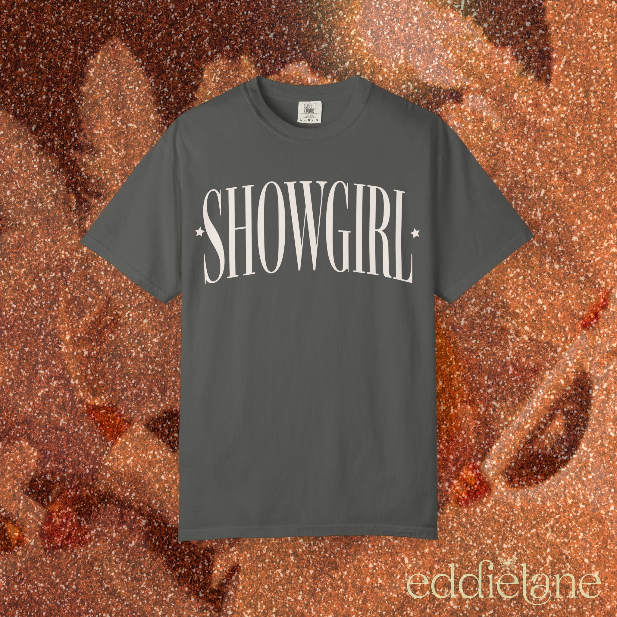 a gray comfort colors graphic tee that says 'SHOWGIRL' with two small stars 

gray showgirl title tee