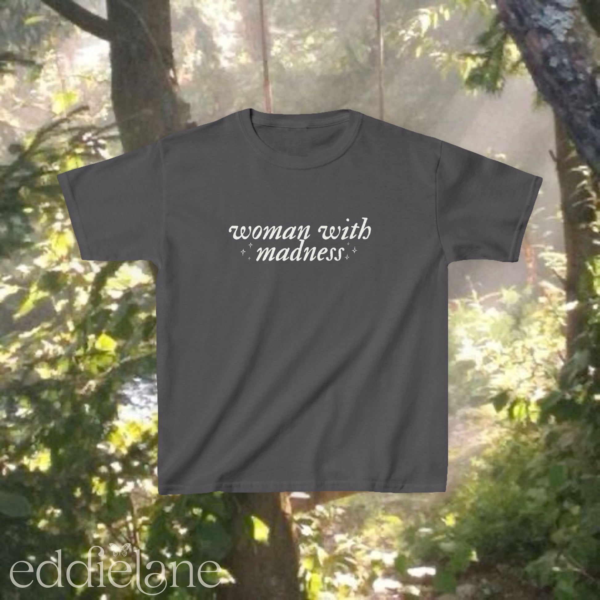 Gray baby tee with words "woman with madness" inspired by the last great american dynasty from folklore by taylor swift.