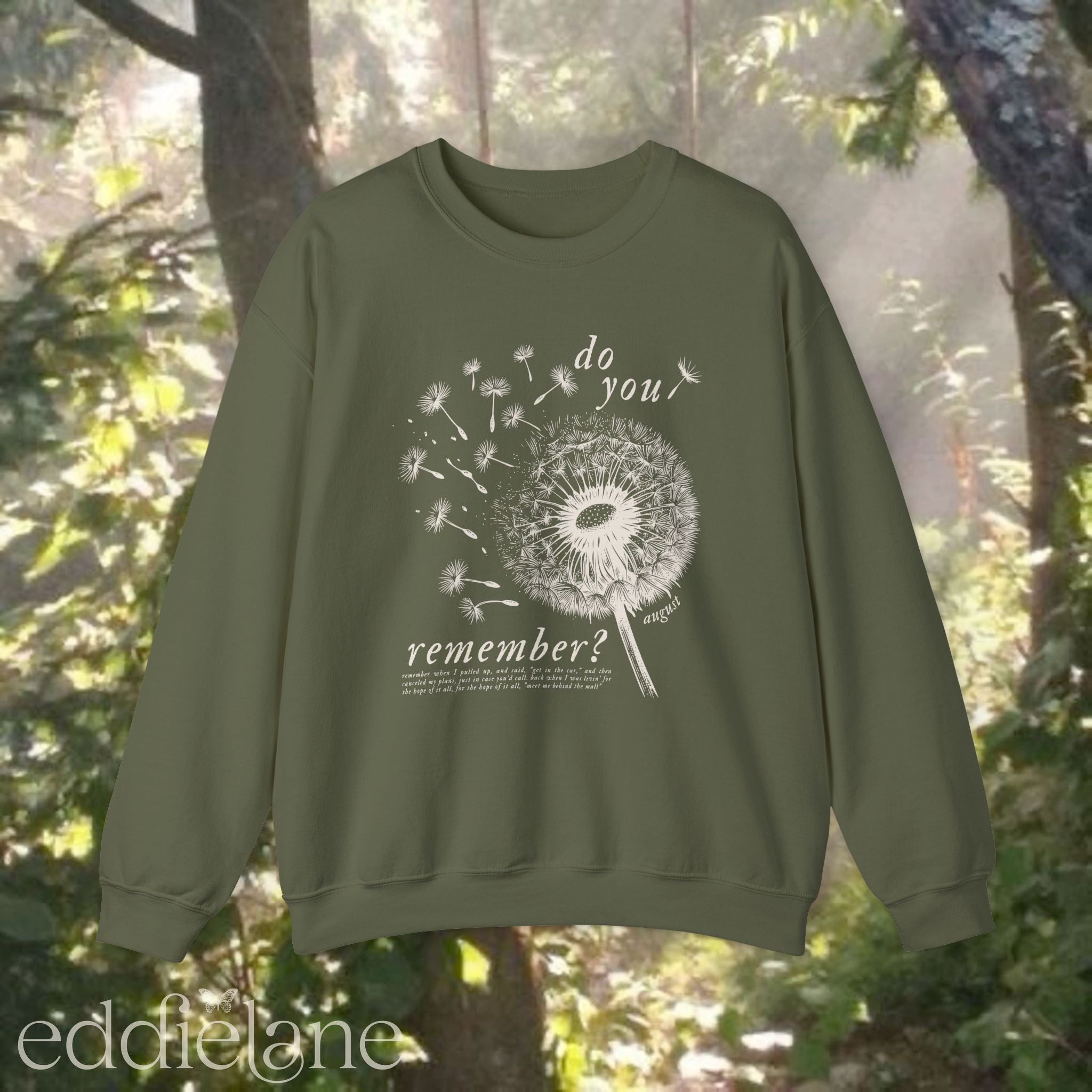 green sweatshirt with dandelion graphic and text that says "do you remember" 