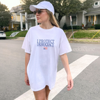 Woman wearing a white comfort colors t-shirt with 'I Protect Democracy' above an upside down american flag
