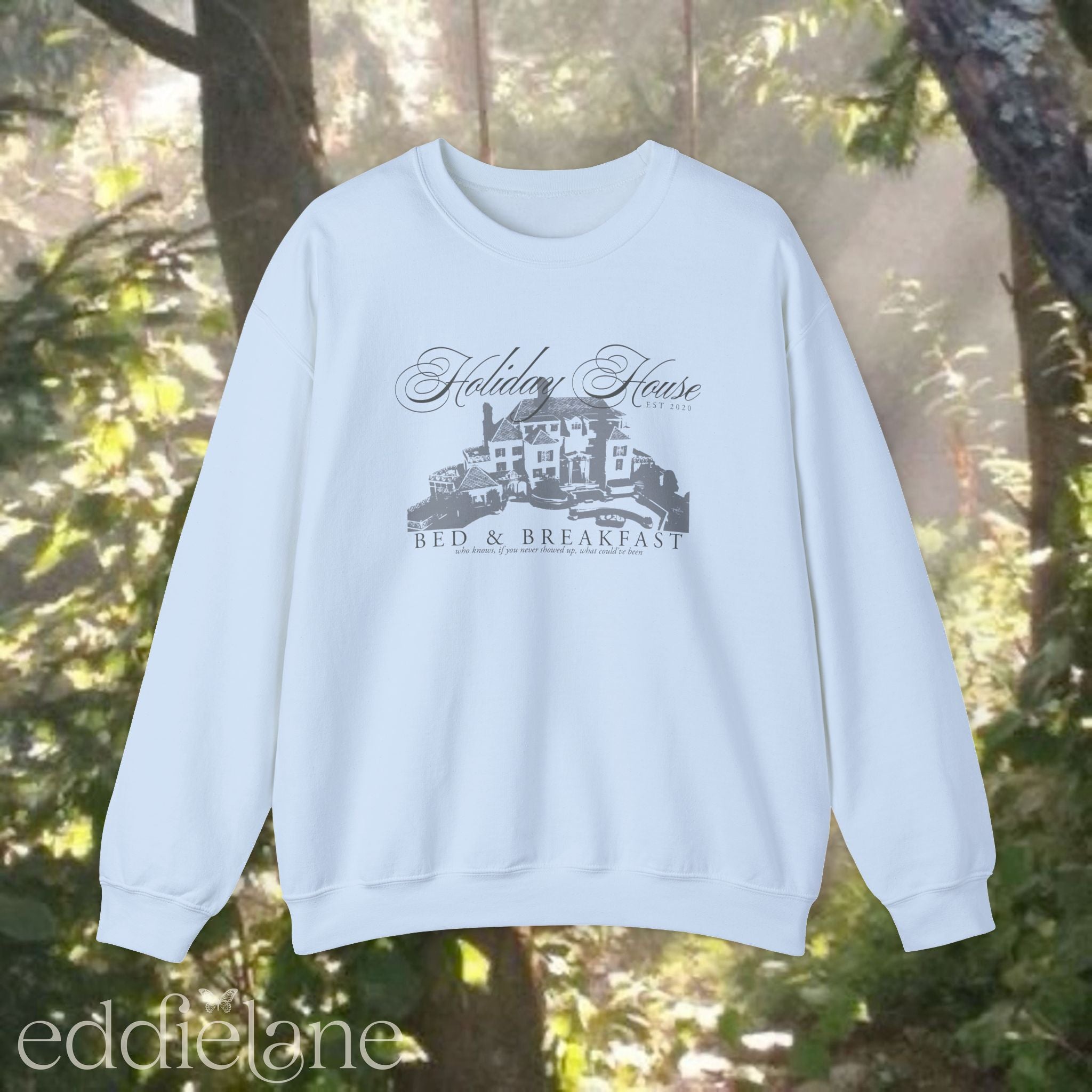 light blue crewneck sweatshirt that says "Holiday House Bed and Breakfast" with a silhouette of the holiday house from taylor swift's the last great american dynasty from folklore.
light blue swiftie sweatshirt holiday house