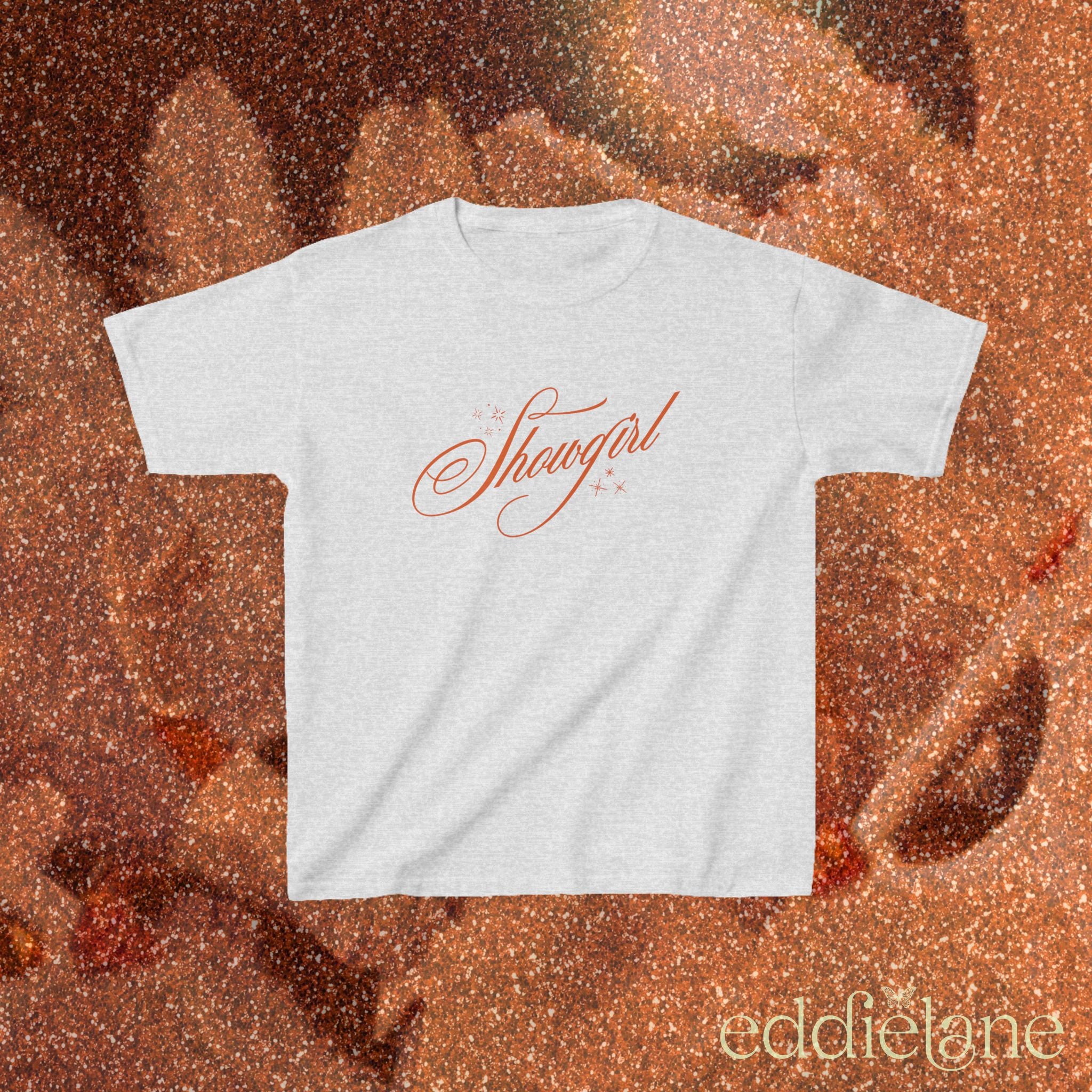 a light gray baby tee with cursive text that says 'Showgirl' 
light gray baby tee