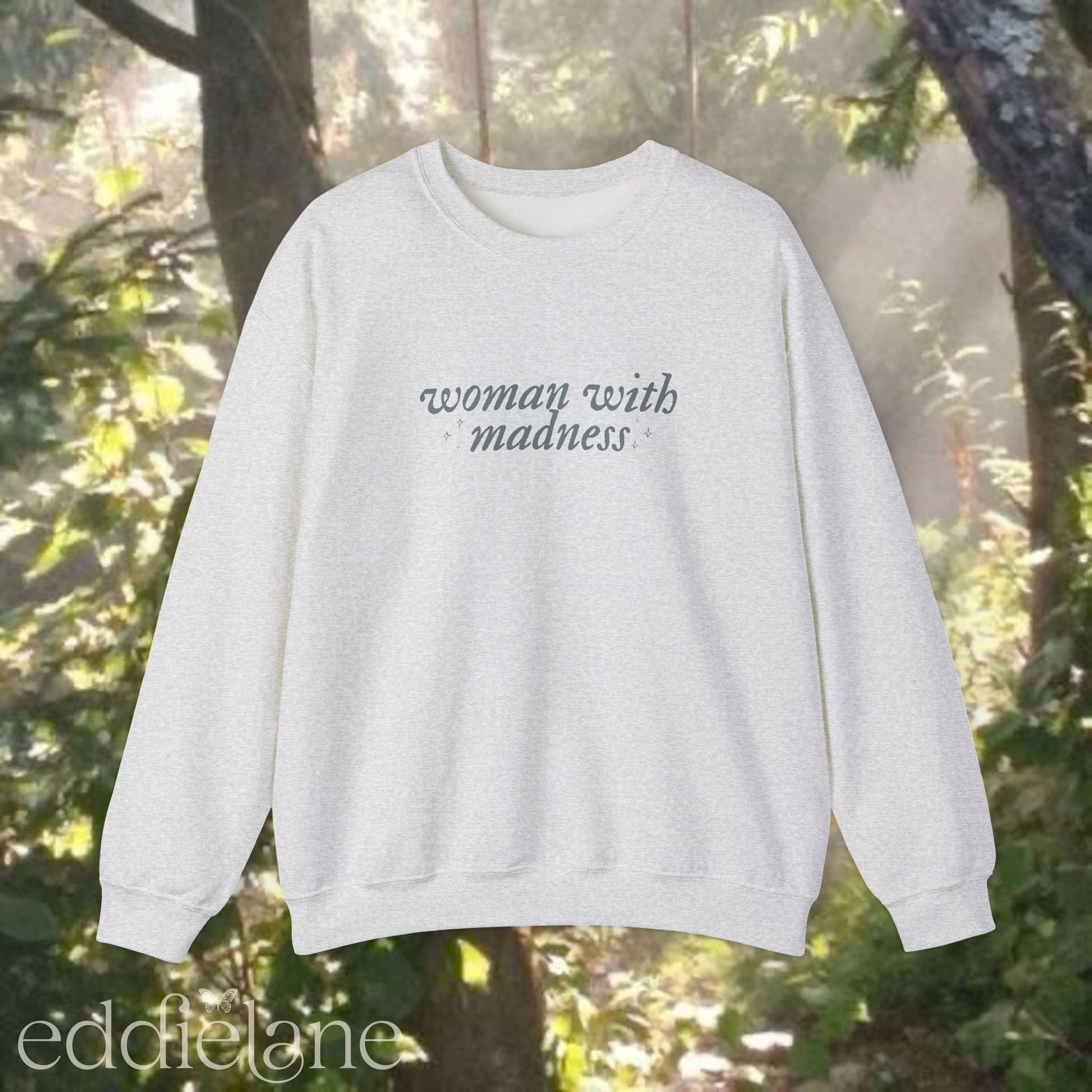light gray sweatshirt with 'woman with madness' inspired by the last great american dynasty from taylor swift's folklore.
light gray swiftie sweatshirt woman with madness
