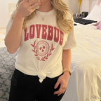 Woman wearing a white t-shirt with 'LOVEBUG" 