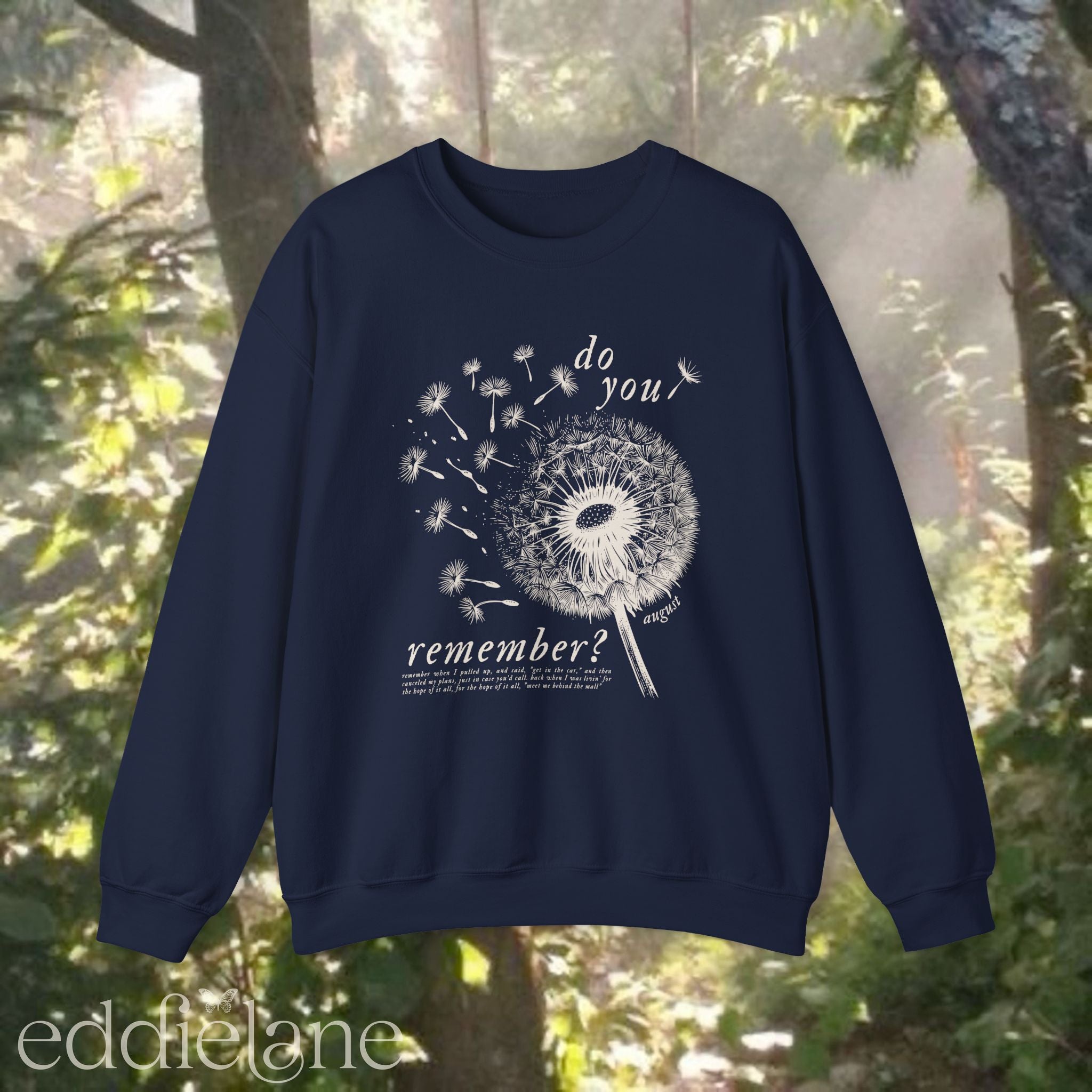 navy sweatshirt with dandelion graphic and text that says "do you remember" 