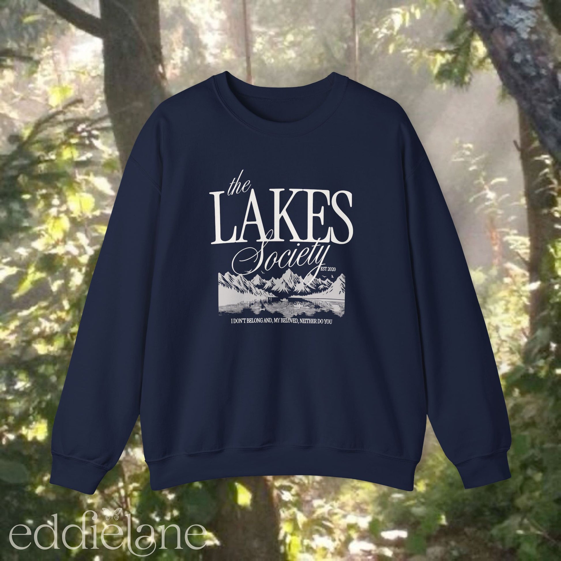navy sweatshirt with 'The Lakes Society' design and a silhouette of a lake surrounded by mountains, inspired by the lakes by taylor swift from folklore.
navy the lakes sweatshirt 